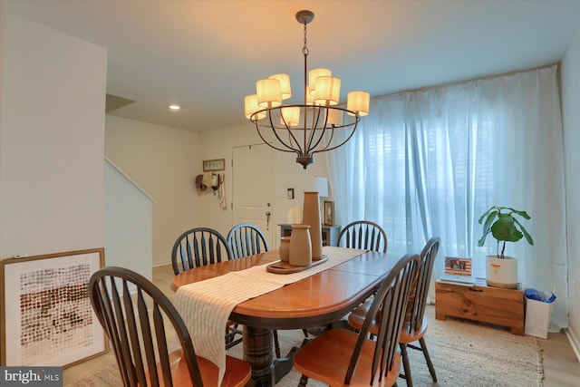 dining area featuring light hardwood / wood-style floors and a notable chandelier