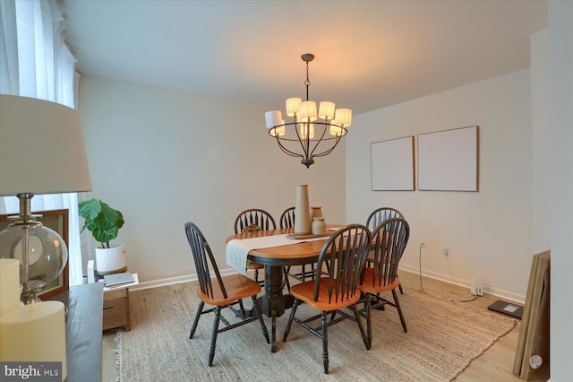 dining area with a chandelier and light wood-type flooring