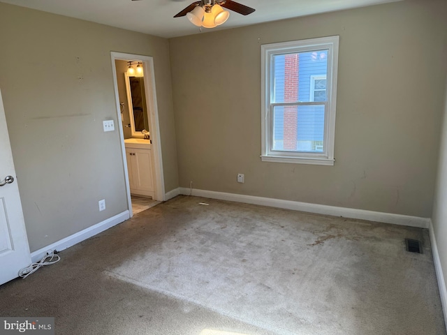 carpeted empty room with ceiling fan and sink