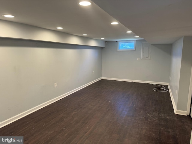 basement featuring dark hardwood / wood-style flooring