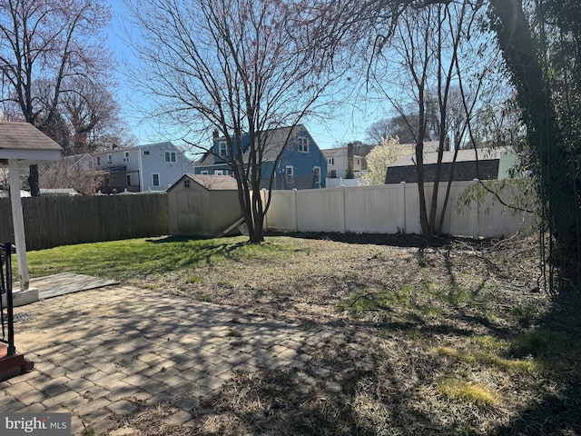 view of yard with a shed and a patio