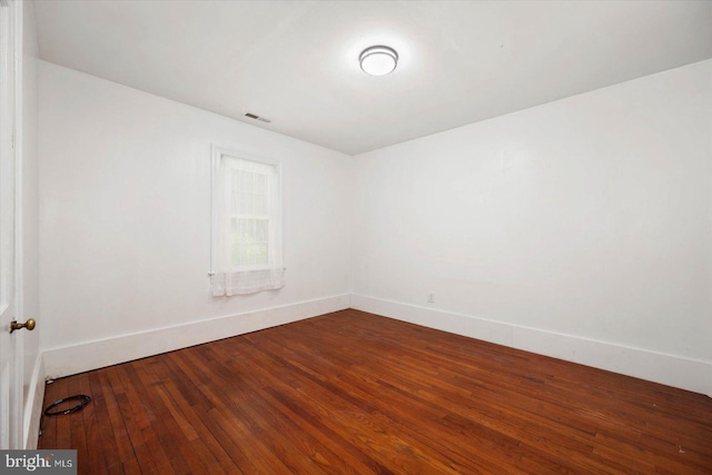 unfurnished room featuring dark hardwood / wood-style flooring