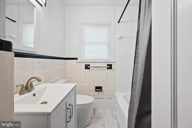 full bathroom with vanity, tile walls, tile floors, toilet, and shower / tub combo