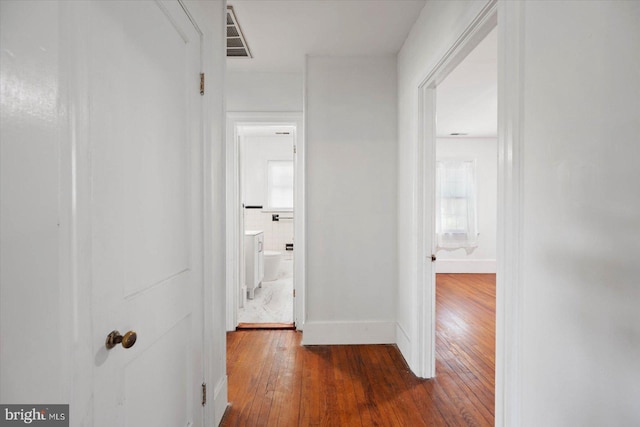 hallway with dark hardwood / wood-style floors