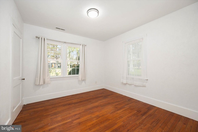 spare room with dark hardwood / wood-style floors