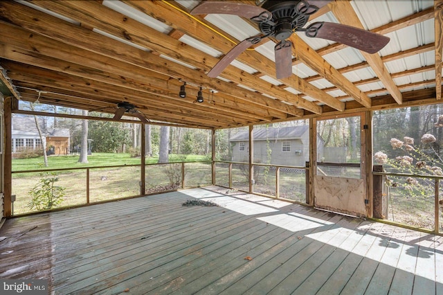 unfurnished sunroom with lofted ceiling, ceiling fan, and a wealth of natural light