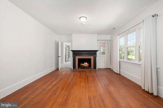 unfurnished living room with a fireplace and hardwood / wood-style floors