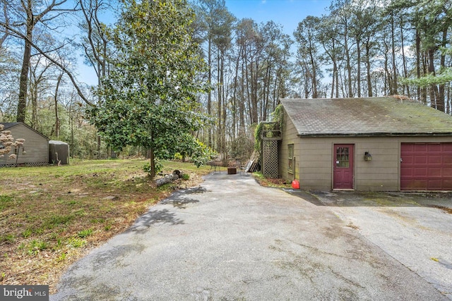 view of side of home featuring an outdoor structure and a garage