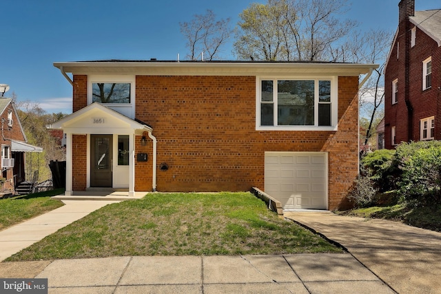 view of front of property with a garage and a front lawn