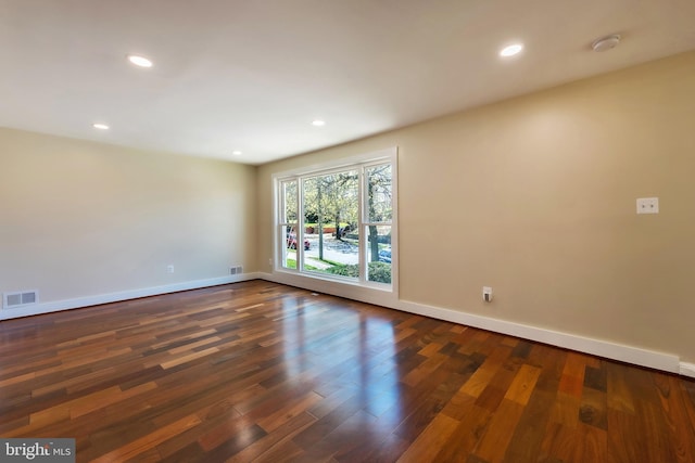 spare room with dark hardwood / wood-style floors