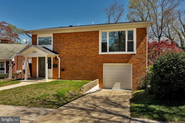 view of front of home with a garage and a front yard