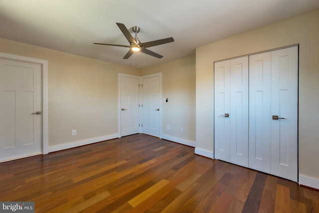 unfurnished bedroom featuring dark hardwood / wood-style floors and ceiling fan