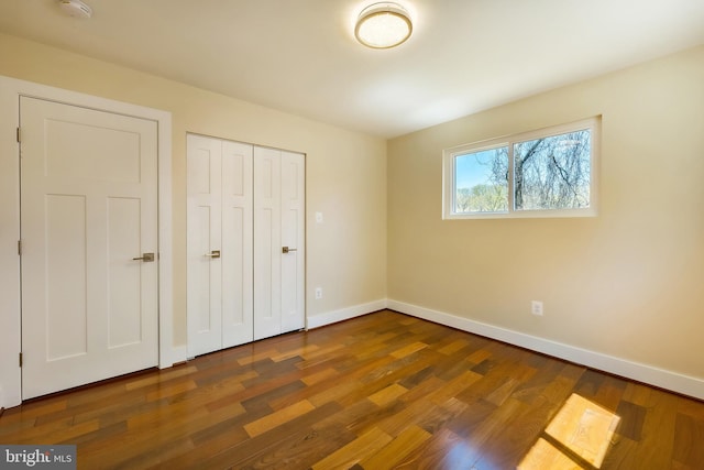 unfurnished bedroom featuring dark wood-type flooring