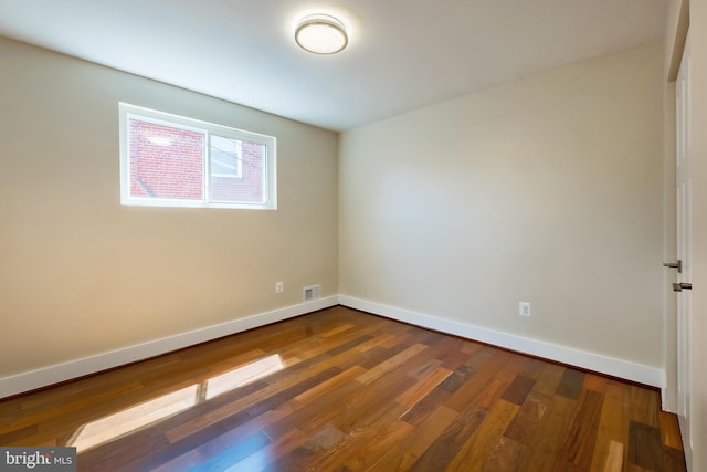 empty room with dark wood-type flooring