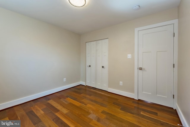 unfurnished bedroom featuring dark wood-type flooring