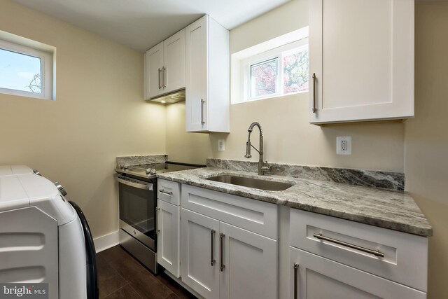 kitchen with dark hardwood / wood-style floors, sink, stainless steel electric stove, and white cabinetry