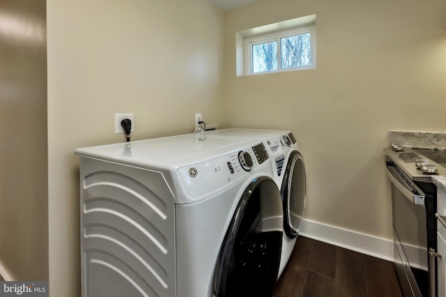 washroom with electric dryer hookup, dark wood-type flooring, and washing machine and clothes dryer