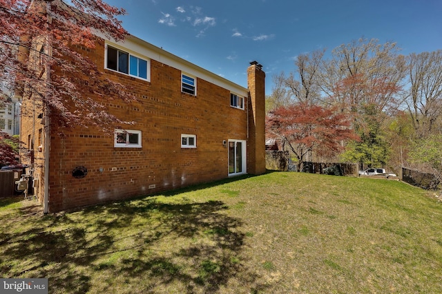 rear view of property featuring a yard