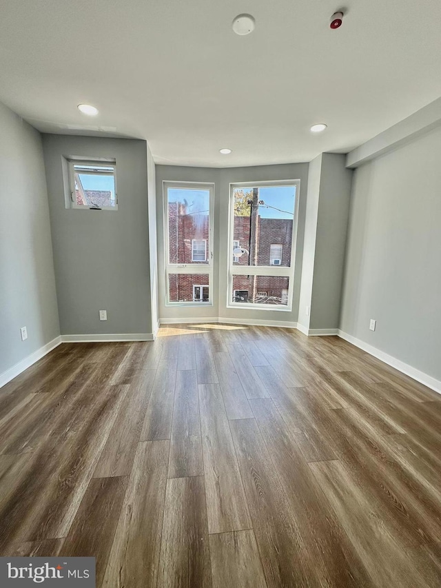 unfurnished room featuring dark hardwood / wood-style floors