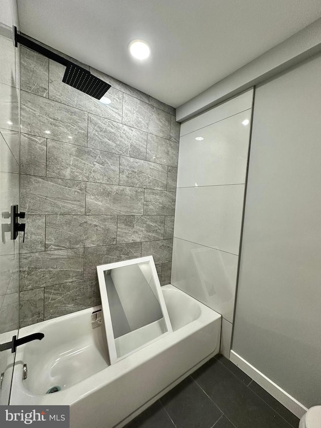 bathroom with tiled shower / bath combo and tile floors