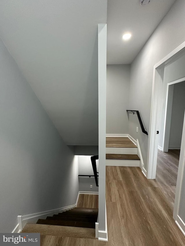 stairway with hardwood / wood-style flooring