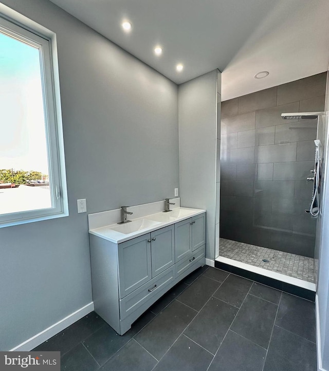 bathroom featuring plenty of natural light, a tile shower, and tile floors