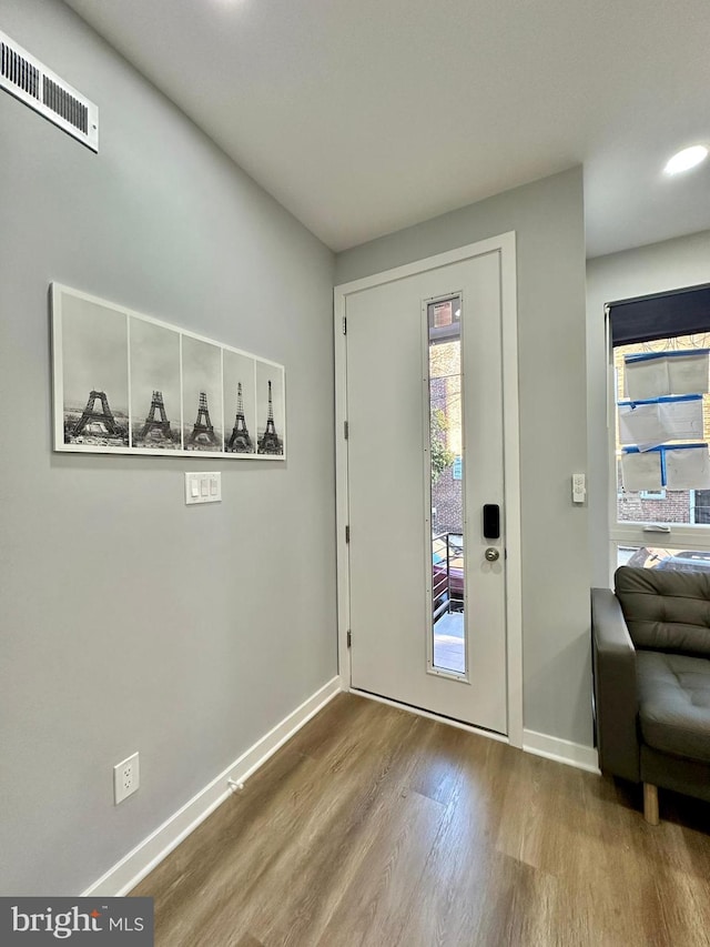 entrance foyer with plenty of natural light and hardwood / wood-style floors