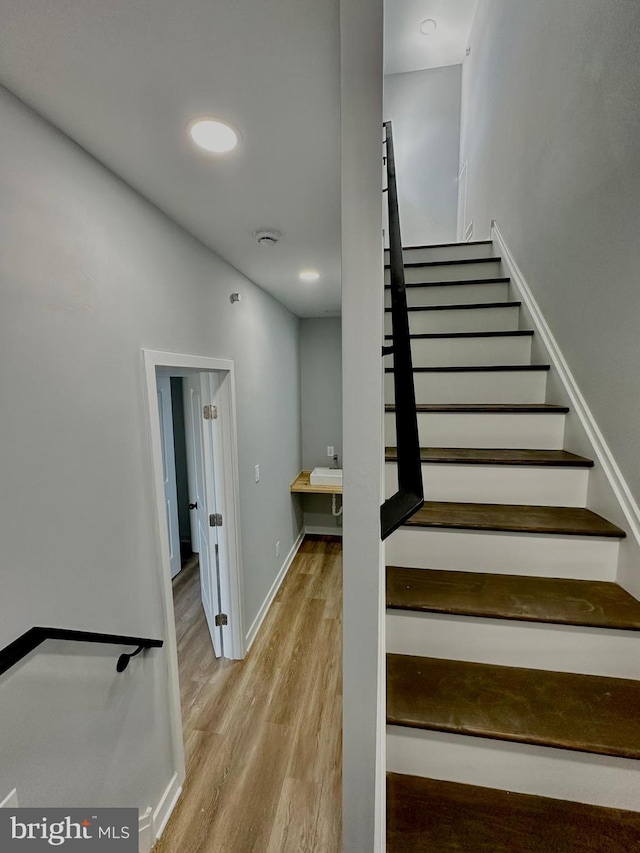 stairs with light hardwood / wood-style flooring