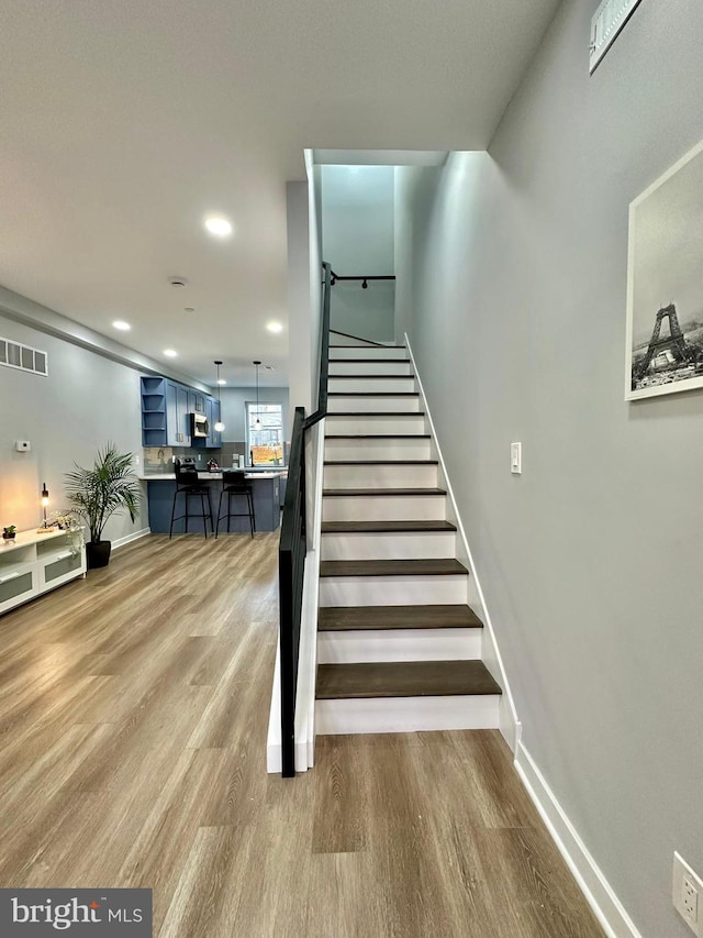 stairs with light wood-type flooring