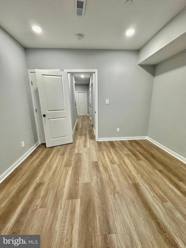 empty room featuring light hardwood / wood-style flooring and a textured ceiling