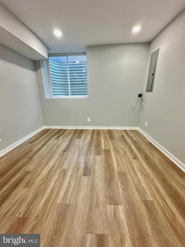 unfurnished room featuring light hardwood / wood-style flooring and a textured ceiling