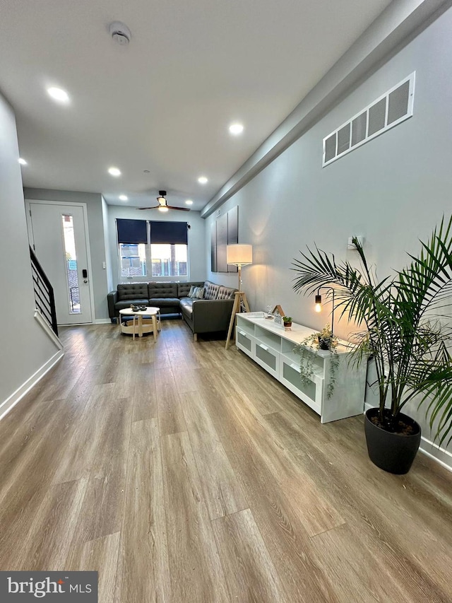 unfurnished living room with ceiling fan and light hardwood / wood-style floors