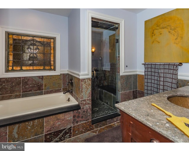 bathroom featuring shower with separate bathtub and vanity