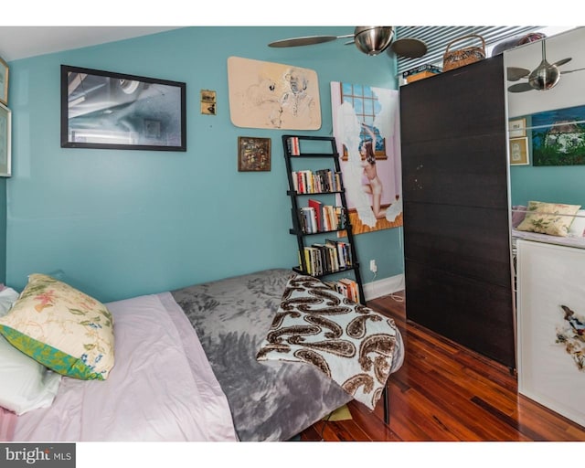 bedroom featuring ceiling fan and dark wood-type flooring