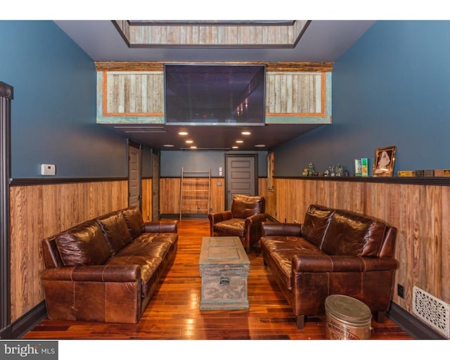 living room with a skylight and dark wood-type flooring