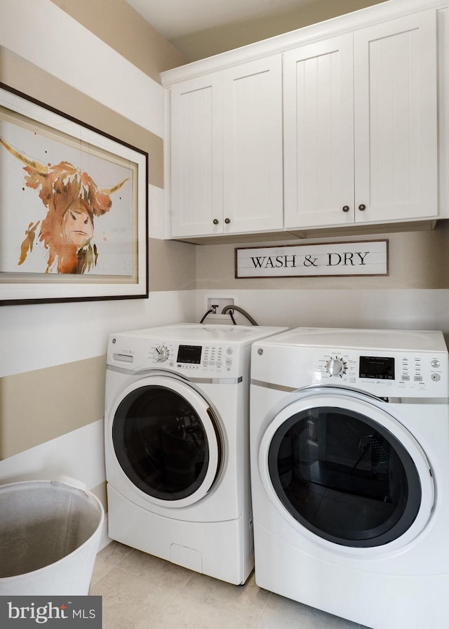 laundry room with cabinets, washer hookup, separate washer and dryer, and light tile floors