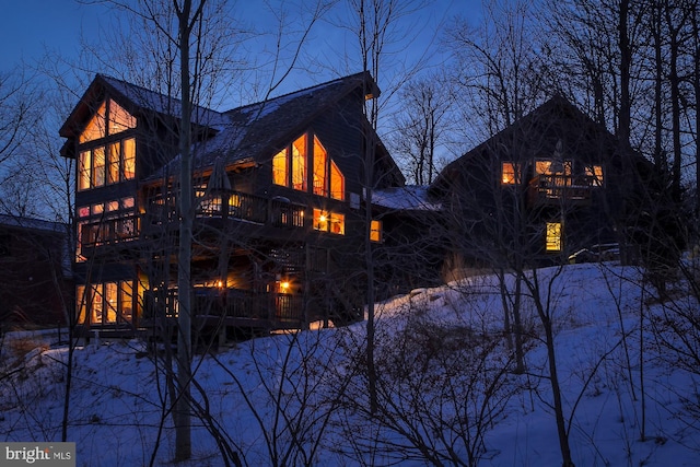 view of snow covered rear of property