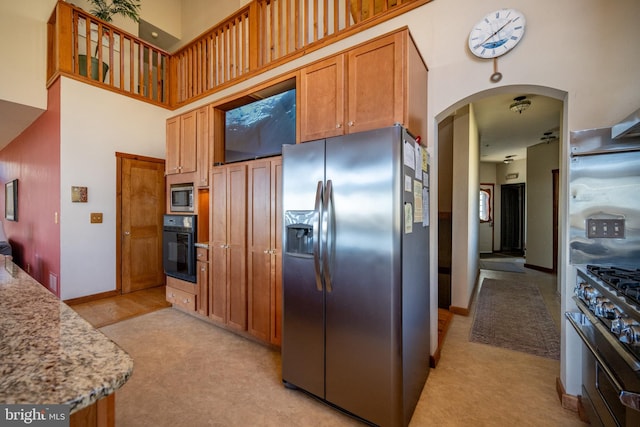 kitchen with light carpet and appliances with stainless steel finishes