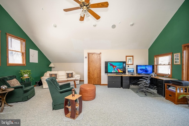 carpeted office space featuring ceiling fan, a healthy amount of sunlight, and vaulted ceiling