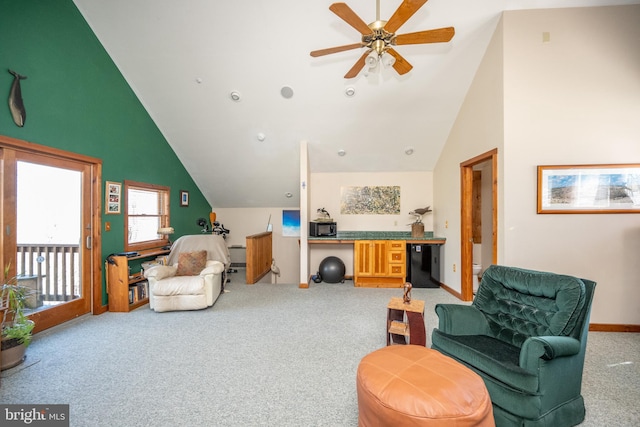 sitting room with ceiling fan, carpet floors, and high vaulted ceiling