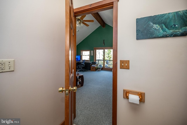 hallway featuring carpet floors and lofted ceiling with beams