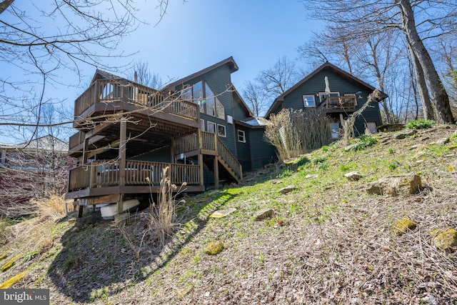 rear view of property featuring a deck