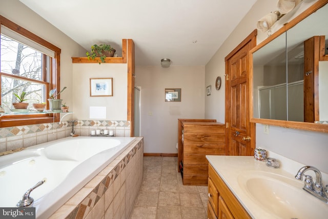 bathroom with tile patterned flooring, shower with separate bathtub, and vanity