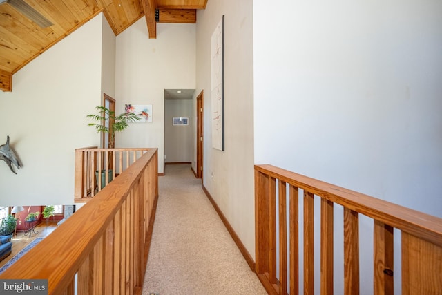 hallway featuring light carpet, vaulted ceiling with beams, and wooden ceiling