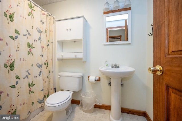 bathroom featuring a shower with curtain and toilet