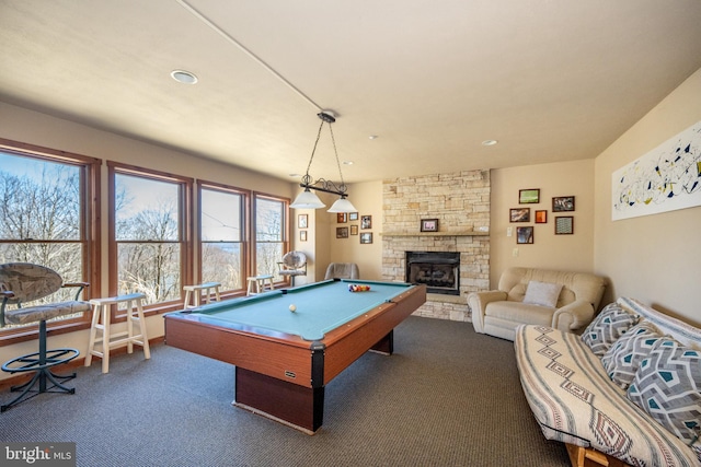 recreation room with a fireplace, dark carpet, and pool table