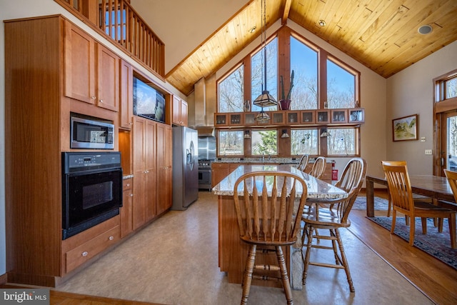 dining room with light hardwood / wood-style floors, high vaulted ceiling, and wood ceiling