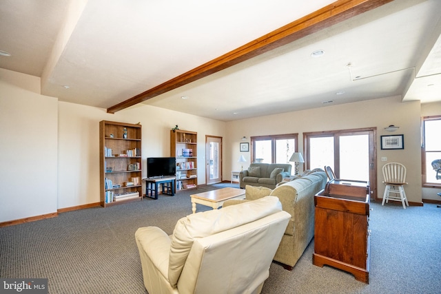 carpeted living room featuring beam ceiling