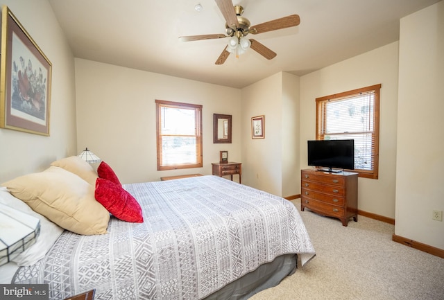 bedroom featuring carpet, multiple windows, and ceiling fan