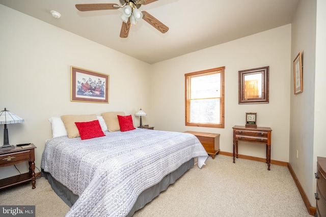 bedroom with ceiling fan and light carpet